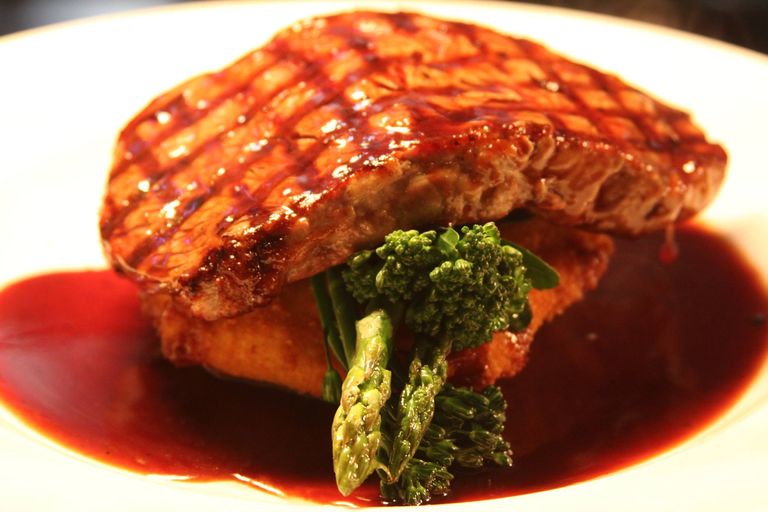 Char grilled steak with greens and jus